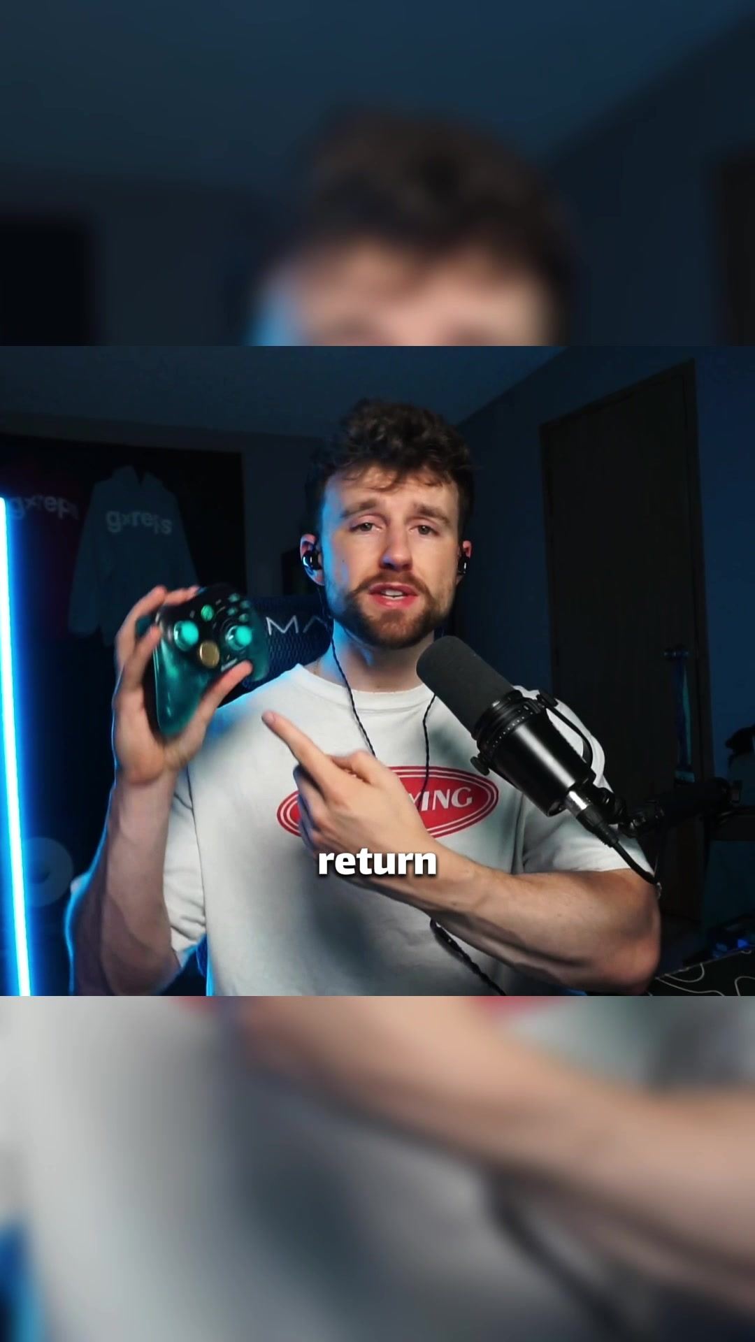 Jace holding the GameSir G7 Pro 8K Aimlabs Edition controller at his streaming setup